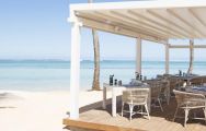 View Heritage Le Telfair Golf  Spa Resort's scenic beachfront restaurant in vibrant Mauritius.